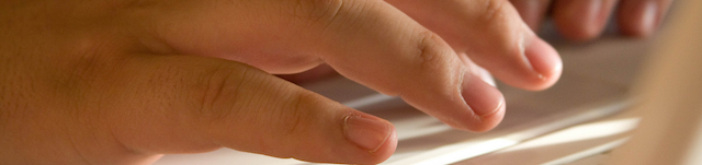 hands on keyboard in sunlight